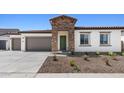 Charming single-story home featuring stone accents, a two-car garage, and desert landscaping at 37727 W Padilla St, Maricopa, AZ 85138