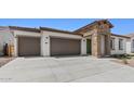 This home boasts a spacious three-car garage, enhancing curb appeal and offering ample parking at 37727 W Padilla St, Maricopa, AZ 85138
