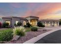 Inviting home exterior with lush greenery and a circular driveway, complemented by a warm color palette at 402 E Windmere Dr, Phoenix, AZ 85048