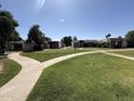 Scenic community shot with winding sidewalk and lawn, showcasing the well-maintained grounds and peaceful environment at 4652 W Desert Crest Dr, Glendale, AZ 85301