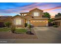 Charming two-story home with well-manicured lawn, desert landscaping, and an inviting facade at dusk at 4976 E Thunderbird Dr, Chandler, AZ 85249