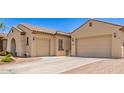 Spacious three-car garage with paved driveway, enhancing curb appeal at 5541 W Desperado Way, Phoenix, AZ 85083