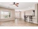 Bright living room featuring natural light, tile floors, and a stylish ceiling fan at 5541 W Desperado Way, Phoenix, AZ 85083