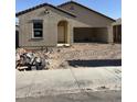 New home under construction, showing the exterior with a two-car garage and an arched entryway at 6029 E Artemis Dr, Florence, AZ 85132