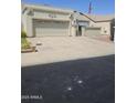 Front exterior of house, including a large driveway leading up to the two car garage at 6036 W Mescal St, Glendale, AZ 85304