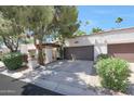 Charming home featuring a two-car garage, mature trees, and meticulously maintained landscaping at 7368 E Pleasant Run, Scottsdale, AZ 85258