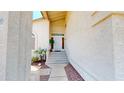 Inviting front entrance with a white front door, desert landscaping, and a welcoming porch at 8541 W Pershing Ave, Peoria, AZ 85381