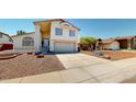 Inviting two-story home featuring a spacious driveway and desert landscaping at 8541 W Pershing Ave, Peoria, AZ 85381