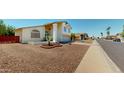 Charming two-story home with gravel landscaping and a well-manicured lawn, on a sunny corner lot at 8541 W Pershing Ave, Peoria, AZ 85381