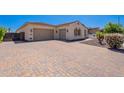 Paver driveway leading to a spacious three-car garage, complementing the home's exterior at 9345 W Robin Ln, Peoria, AZ 85383