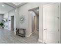 Bright foyer with neutral color palette, decorative mirror, and views into other rooms at 9345 W Robin Ln, Peoria, AZ 85383