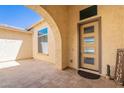 Inviting front entry with a modern door, covered porch and desert welcome decor at 9345 W Robin Ln, Peoria, AZ 85383