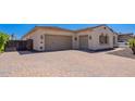 Spacious two-car garage and driveway with brick pavers for a polished look at 9345 W Robin Ln, Peoria, AZ 85383