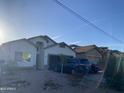 Single-Gathering home with two cars parked in the driveway, desert landscaping, and an attached two-car garage at 10006 N 7Th Pl, Phoenix, AZ 85020
