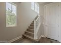 Bright staircase featuring hardwood floors and contemporary white railing at 11300 N Casa Dega Dr # 1019, Surprise, AZ 85388