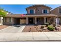 Two-story home featuring a covered porch and a three car garage at 12601 W San Miguel Ave, Litchfield Park, AZ 85340