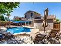 Backyard pool with an in-ground pool and patio furniture for relaxing and enjoying the outdoors at 12601 W San Miguel Ave, Litchfield Park, AZ 85340