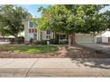 Charming two-story home showcasing mature trees, a well-manicured lawn, and a welcoming facade at 1406 E Jasper Dr, Chandler, AZ 85225