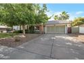 Well-maintained single-Gathering home with a spacious driveway and attached two-car garage at 1406 E Jasper Dr, Chandler, AZ 85225