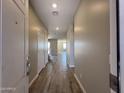 An entryway reveals beautiful wood-look tile flooring leading to a bright, open living space at 17493 W Fulton St, Goodyear, AZ 85338