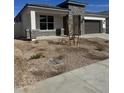 A modern home featuring stone veneer accents and a well-maintained front yard with xeriscape landscaping at 17778 W Turquoise Ave, Waddell, AZ 85355