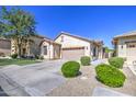 Inviting home featuring a desert landscape, a two-car garage, and a neutral color palette at 1831 S Hudson Dr, Chandler, AZ 85286