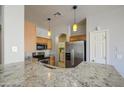 Well-lit kitchen featuring stainless steel appliances, granite countertops, and hanging pendant lights at 1831 S Hudson Dr, Chandler, AZ 85286