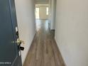 Bright entryway featuring neutral walls and wood-look tile flooring leading to an open floor plan at 18361 W Jessie Ln, Surprise, AZ 85387
