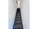 A straight carpeted stairway with gray walls and white railing at 19777 N 76Th N St # 2243, Scottsdale, AZ 85255