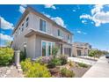 Two-story home featuring manicured landscaping, a spacious driveway, and a modern exterior design at 21134 W Minnezona Ave, Buckeye, AZ 85396
