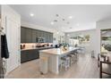 Well-designed kitchen with a large center island, pendant lights, and stainless steel appliances at 21134 W Minnezona Ave, Buckeye, AZ 85396