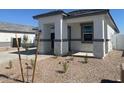 Inviting single-story home featuring stone accents, gravel landscaping, and an attached two-car garage at 25481 W Graham Trl, Buckeye, AZ 85326