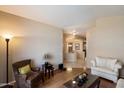 Cozy living room featuring hardwood floors, tan walls and comfortable seating at 3350 E Rosemonte Dr, Phoenix, AZ 85050
