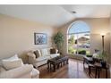 Bright living room with a large window, hardwood floors, and neutral decor at 3350 E Rosemonte Dr, Phoenix, AZ 85050