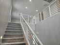 Interior view of a staircase with carpeted steps and modern, silver railings at 3354 S 180Th Ln, Goodyear, AZ 85338