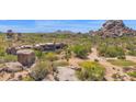 View of backyard with freeform pool and spa, and desert landscaping at 35180 N Boulder Pass, Scottsdale, AZ 85266