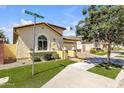 Beautiful single-story home with arched window and stone accents and desert landscaping at 3634 E Perkinsville St, Gilbert, AZ 85295