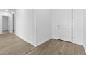 Clean and bright entryway with wood-look floors and white walls at 37735 W Santa Maria St, Maricopa, AZ 85138