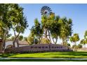 Power Ranch community entrance with a windmill on a manicured lawn under a blue sky at 3837 E Santa Fe Ln, Gilbert, AZ 85297