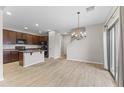 Open-concept kitchen and dining area with stainless steel appliances and tile flooring at 3837 E Santa Fe Ln, Gilbert, AZ 85297