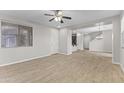 Spacious living room with tile floors, a ceiling fan, and plenty of natural light at 3837 E Santa Fe Ln, Gilbert, AZ 85297