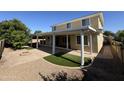 Backyard showcasing covered patio, gravel beds, pavers, and artificial turf, perfect for outdoor living at 4109 E Sierra Madre Ave, Gilbert, AZ 85296
