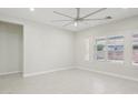 Bright bedroom with large windows, tile flooring, a modern ceiling fan, and neutral paint at 4109 E Sierra Madre Ave, Gilbert, AZ 85296