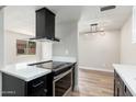 Kitchen featuring a black vent hood and modern electric range oven at 4228 N 81St St, Scottsdale, AZ 85251
