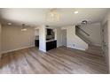 Spacious living room features hardwood floors, modern lighting, and open kitchen at 4228 N 81St St, Scottsdale, AZ 85251