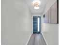 Bright entryway features modern light fixture, a sleek front door with glass inserts, and clean white trim at 5236 S 19Th Ave, Phoenix, AZ 85041