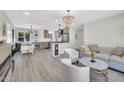 Open-concept living space with modern furnishings, stylish lighting, and seamless flow to the kitchen at 5236 S 19Th Ave, Phoenix, AZ 85041