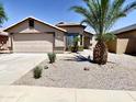 Charming single Gathering home showcasing mature palm trees, well maintained landscaping, and a 2 car garage at 5749 S 247Th Dr, Buckeye, AZ 85326