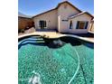 Inviting backyard pool with waterfall feature and easy access to the home through sliding glass doors at 5749 S 247Th Dr, Buckeye, AZ 85326