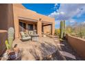 Relaxing covered patio with comfortable outdoor furniture and desert views at 5892 E Carefree Mountain Dr, Carefree, AZ 85377